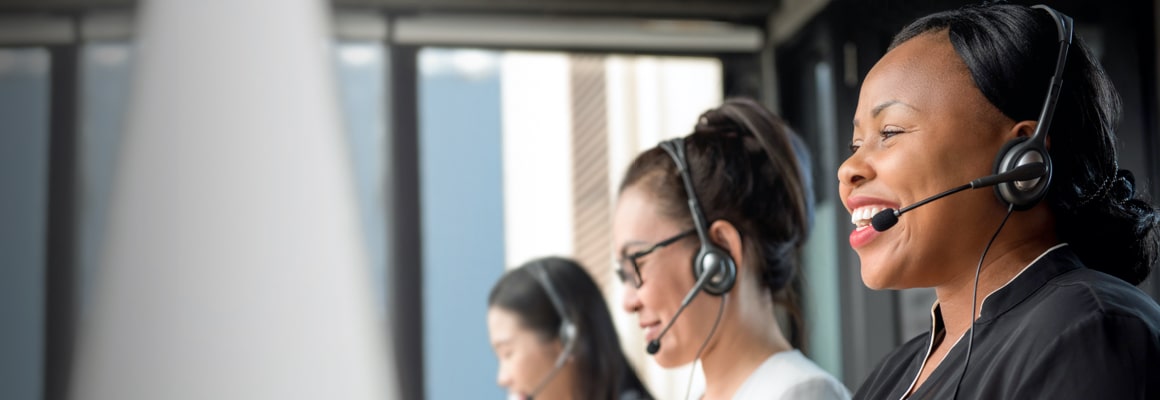 Three trained legal receptionist speaking on headphones