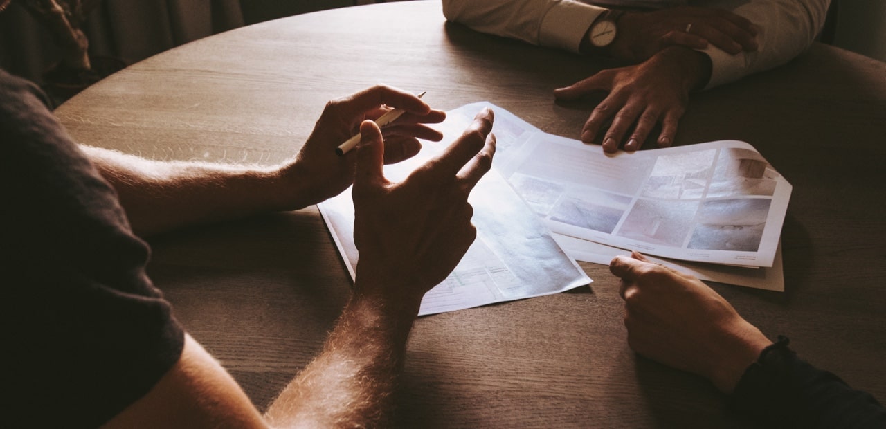 Three people discussing over table