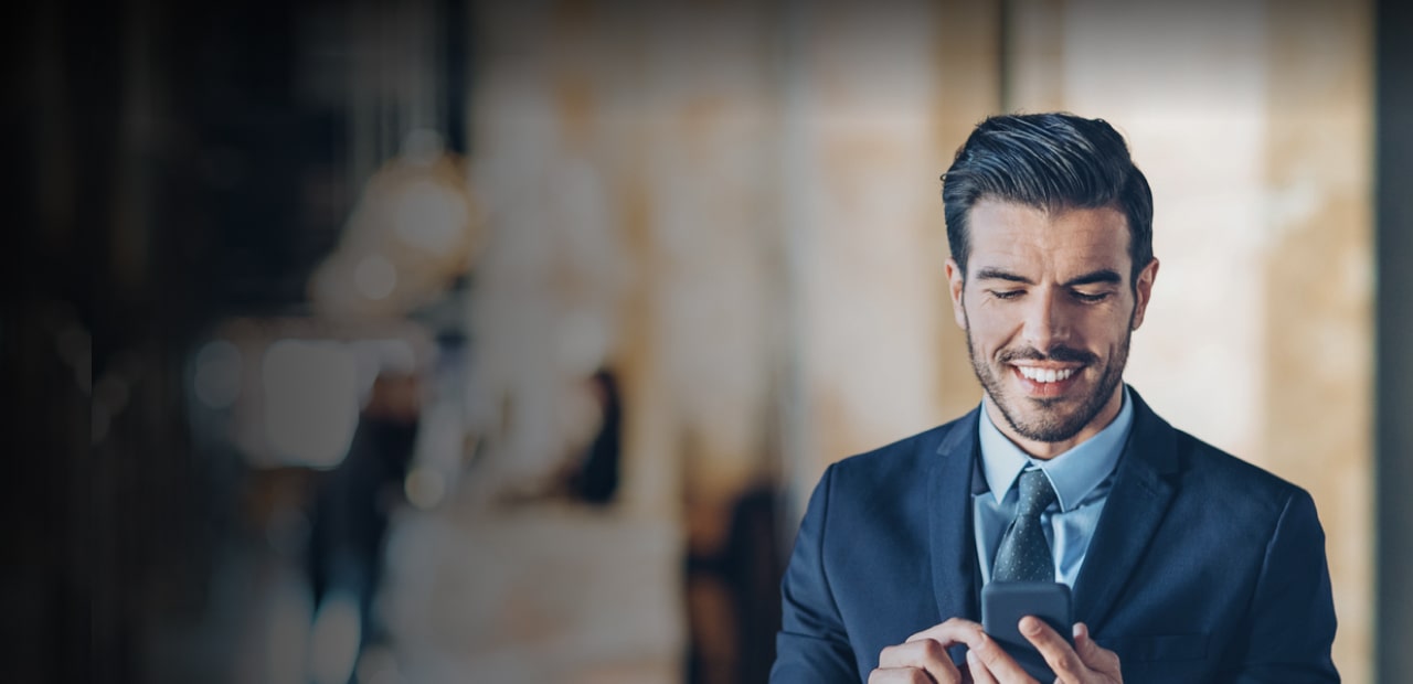 Man in blue suit using mobile