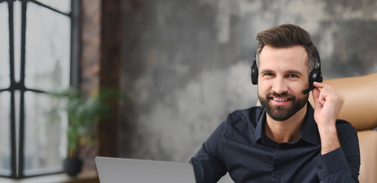 Male receptionist wearing headphone