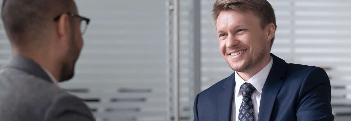 Smiling man wearing blue coat
