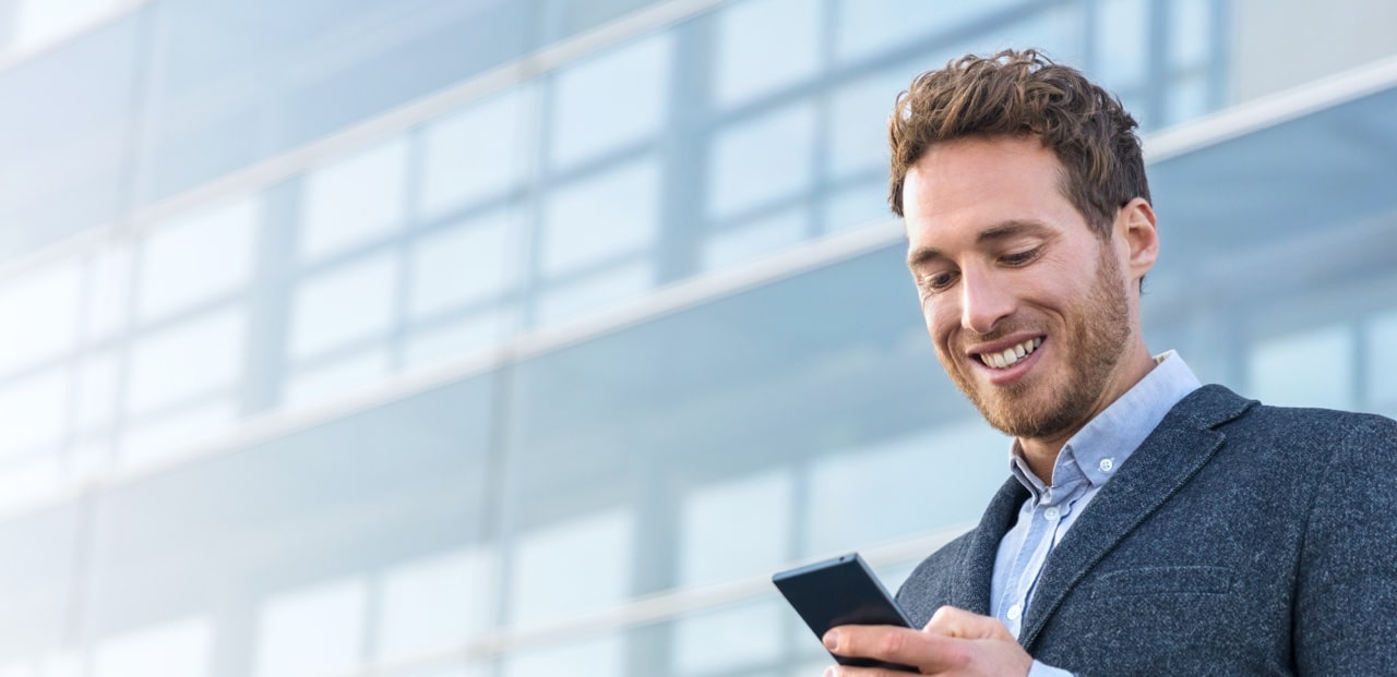 Smiling man looking at the phone