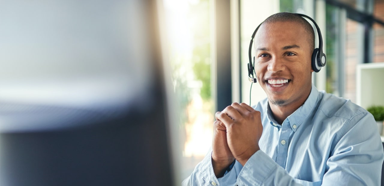Male receptionist speaking over headphones